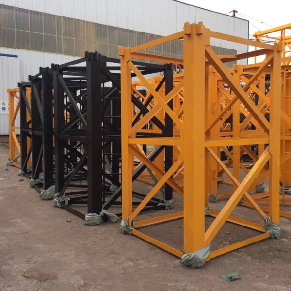 Stacked steel frames with orange supports, likely used for a QTZ50 TC4810 4 Ton Tower Crane or heavy-duty scaffolding, standing on a concrete surface.