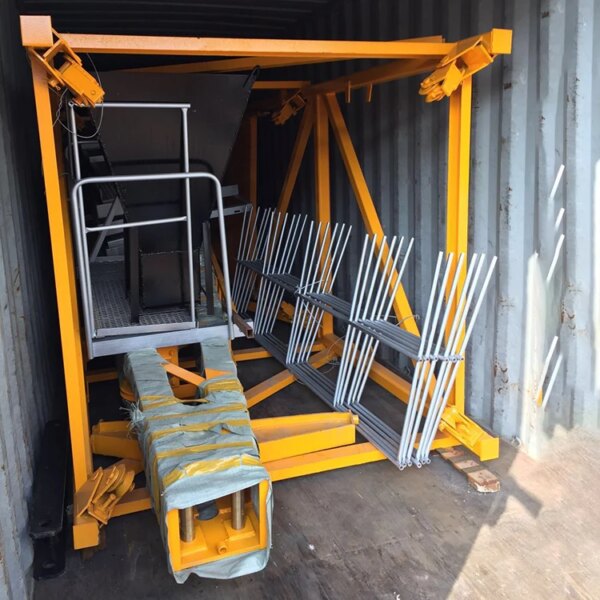 Metal construction materials, including a QTZ50 TC4810 4 Ton Tower Crane, secured inside a shipping container for transport.