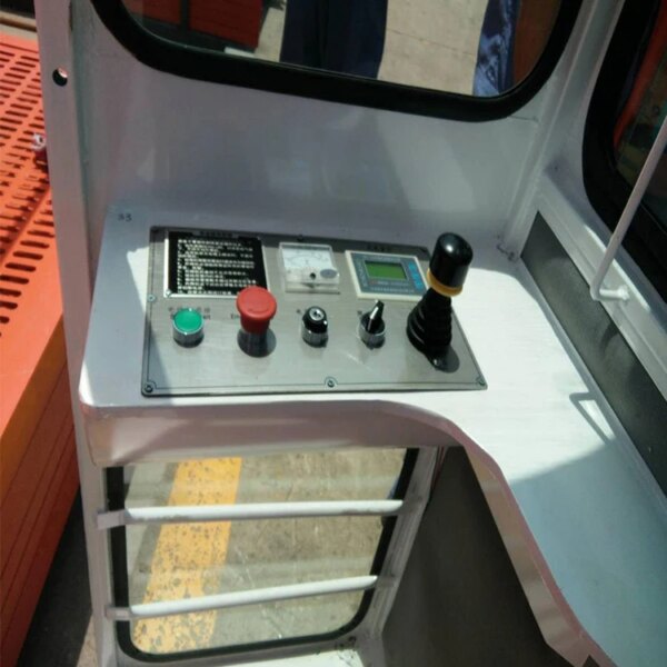 Control panel of a Building Material Construction Hoist for sale with joystick and buttons, viewed from above.