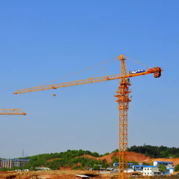 Construction hot sale China brand self-erecting tower cranes and construction lifts at a building site with clear blue sky in the background.