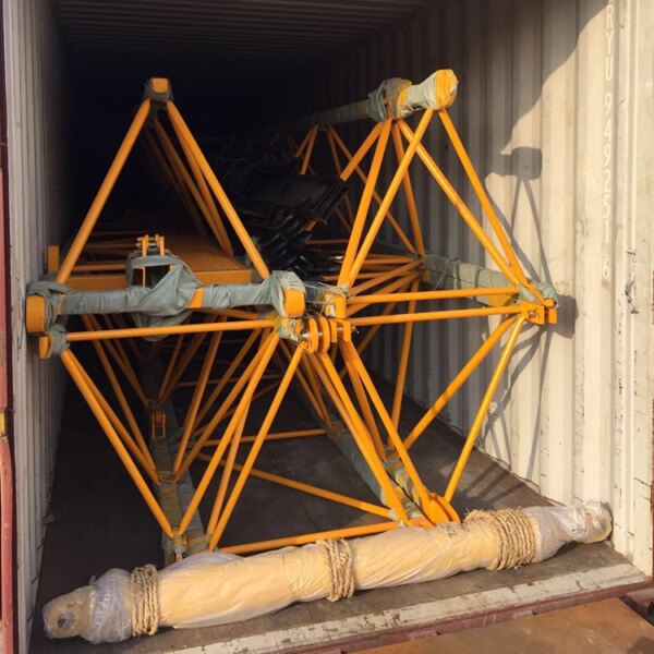 Large yellow steel Hot sale china brand self erecting construction lift hammerhead tower crane structure secured inside a shipping container.