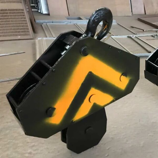 A blacksmith's steel anvil painted with a yellow and orange flame design, showcased on a metal surface near the base of a IHURMO 5T TC5011 QTZ63 Tower Crane for Building.