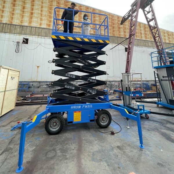 Two individuals on a IHURMO Electric 500kg 19 Foot Scissor Lift platform in an industrial setting.