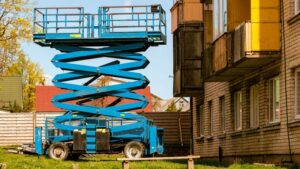 High-quality blue mobile scissor lift used for building maintenance and construction tasks. Equipped with safety rails and extendable platform for elevated work.